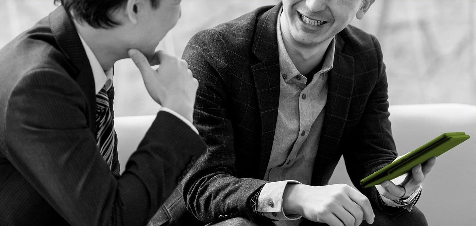 two men in suits chatting together